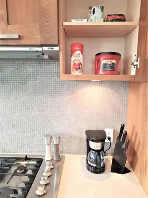 a kitchen with a stove and a counter top at Luxury Condo by River with City Views in Calgary