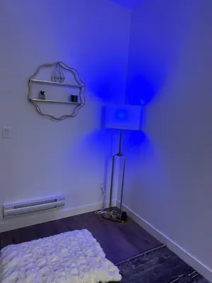 a blue room with a bed and a lamp at A Cozy Private Suite in Rangeview, SE Calgary in Calgary
