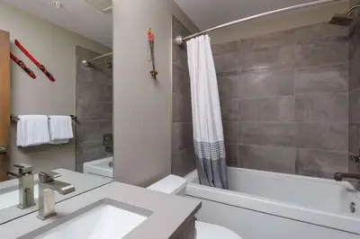a bathroom with a sink and a tub and a shower at Stonegate Resort Unit B206 in Kelowna