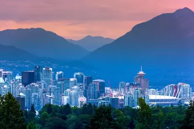 a cityscape of a city with mountains in the background at Stunning Skyline Views in a Cozy and Stylish Abode in Vancouver