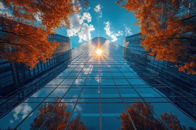a tall glass building with the sun in the sky at Stunning Skyline Views in a Cozy and Stylish Abode in Vancouver