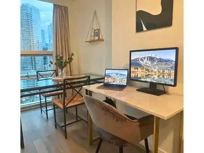 a living room with a desk with a computer on it at City Retreat With Views in the Heart of Downtown in Vancouver