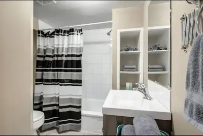 a bathroom with a sink and a shower at Ceruleans 3BR Suite in Calgary in Calgary