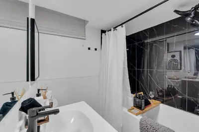 a bathroom with a sink and a shower at Luxury Suite, Steps to Calgary DT, River, Hospital in Calgary