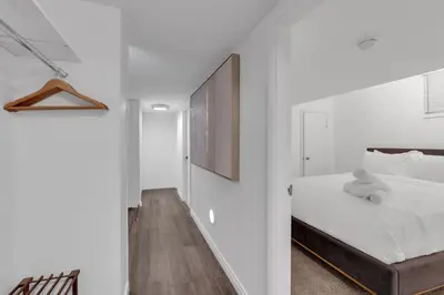 a bedroom with a bed with a teddy bear on it at Luxury Suite, Steps to Calgary DT, River, Hospital in Calgary