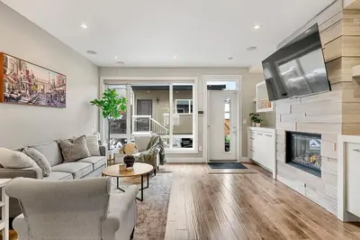 a living room with a couch and a fireplace at Luxury Cityscape Retreat with Hot Tub in Calgary