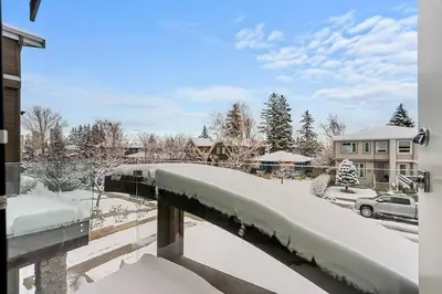 a bridge covered in snow next to a house at Luxury Cityscape Retreat with Hot Tub in Calgary
