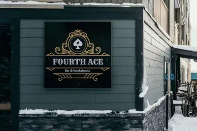 a sign for a fourth age restaurant on the side of a building at The Lifty Ski-In Ski-Out Studio, Pool and Gym in Big White