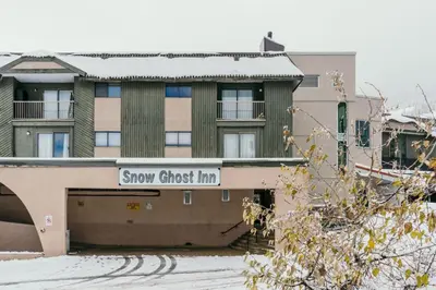 a building with a sign that reads show guest inn at The Dorm Ski-In Ski-Out Studio, Pool and Gym in Big White