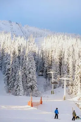 a group of people on a ski lift in the snow at The Dorm Ski-In Ski-Out Studio, Pool and Gym in Big White