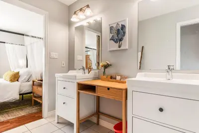 a bathroom with two sinks and a mirror at EmeraldRidge Retreat - 180 Degree Amazing View & Firepit & BBQ in Chilliwack
