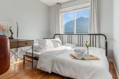 a bedroom with a bed with a tray of towels at EmeraldRidge Retreat - 180 Degree Amazing View & Firepit & BBQ in Chilliwack