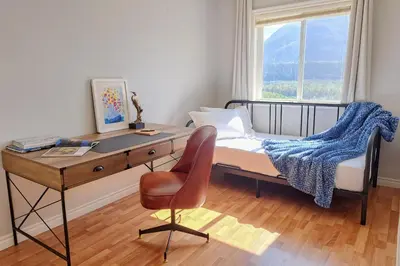 a bedroom with a desk and a bed and a chair at EmeraldRidge Retreat - 180 Degree Amazing View & Firepit & BBQ in Chilliwack