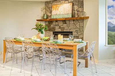 a dining room with a wooden table and chairs at EmeraldRidge Retreat - 180 Degree Amazing View & Firepit & BBQ in Chilliwack