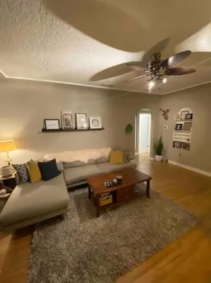 a living room with a couch and a ceiling fan at Walk to the beaches and the restaurants downtown! in Kelowna