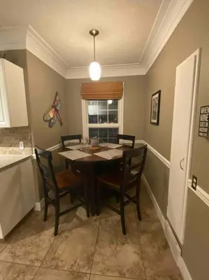 a dining room with a table and chairs and a window at Walk to the beaches and the restaurants downtown! in Kelowna
