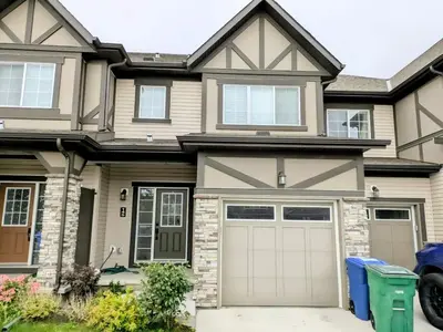 a house with a garage at A Slice of Heaven in Airdrie by EaglesWingsHomes1 in Airdrie