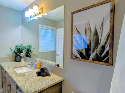 a bathroom with a sink and a mirror at A Slice of Heaven in Airdrie by EaglesWingsHomes1 in Airdrie