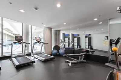 a gym with cardio equipment and a large mirror at Stylish Condo in Downtown in Vancouver