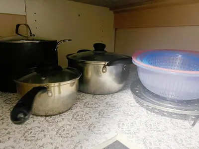 three pots and pans sitting on a counter top at Two Bedrooms- A Warm House in Vancouver