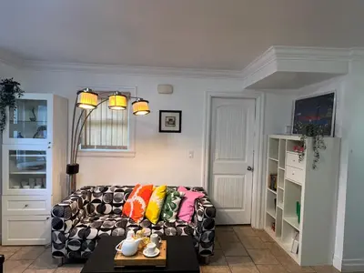 a living room with a couch with colorful pillows at Two Bedrooms- A Warm House in Vancouver