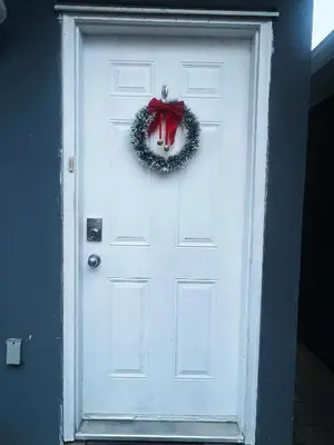 a white door with a wreath on it at Two Bedrooms- A Warm House in Vancouver