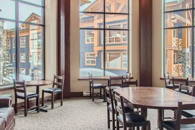 a restaurant with tables and chairs and large windows at Stonegate Resort Unit A403 in Kelowna