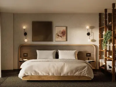 a bedroom with a large bed with white sheets at The Kenrick Hotel in Banff