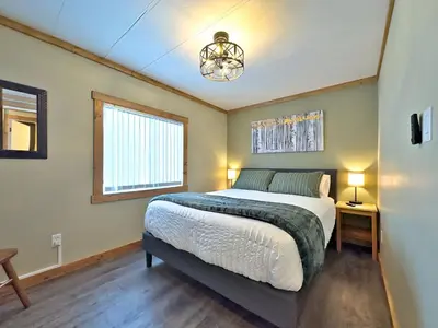 a bedroom with a large bed and a window at Hillcrest Hideaway: Spacious Mountain View Oasis in Hillcrest Mines