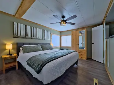 a bedroom with a bed and a ceiling fan at Hillcrest Hideaway: Spacious Mountain View Oasis in Hillcrest Mines