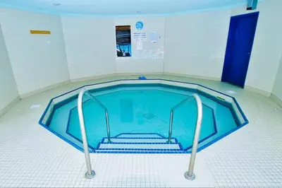a swimming pool in a room with stairs in it at Relaxing Mountain Getaway at Mystic Springs in Canmore