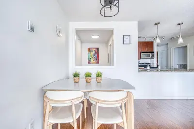 a kitchen with a table and four chairs at Great Ocean Mountain & City views with one free parking in Vancouver