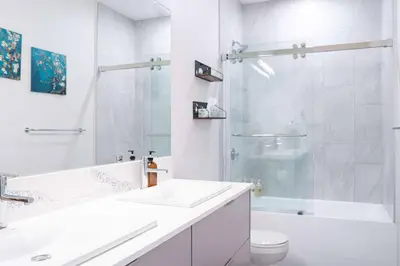a white bathroom with a sink and a shower at Alpine Retreat by Revelstoke Vacations in Revelstoke