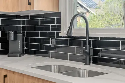 a kitchen counter with a sink and a window at 3bd Luxury Home, Steps to Calgary DT, River, Hospital in Calgary