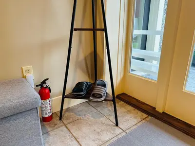 a tripod stand next to a door with a window at Cozy Home in Dunbar in Vancouver