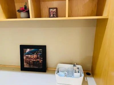 a picture on a shelf with a box on the floor at Cozy Home in Dunbar in Vancouver