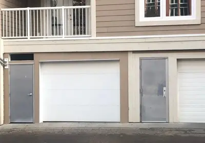 two garage doors on the side of a house at Ice District 2 Kings Underground Park Patio in Edmonton