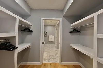 a walk in closet with shelves and a hallway at Ice District 2 Kings Underground Park Patio in Edmonton