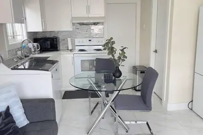 a kitchen with a glass table with a vase on it at Modern Spacious 1BR minutes away from Main St in Vancouver