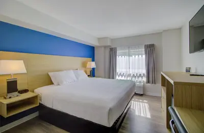 a hotel room with a large bed and a window at Baymont by Wyndham Gold River in Gold River