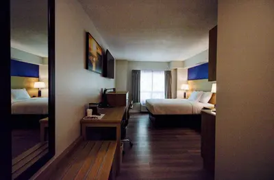 a hotel room with two beds and a mirror at Baymont by Wyndham Gold River in Gold River