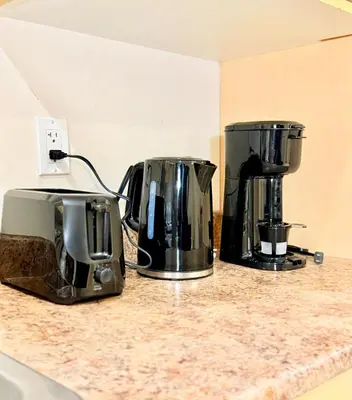 two coffee machines sitting on a kitchen counter at Modern & Cozy 2-Bed Suite in Vancouver in Vancouver