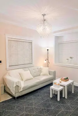 a living room with a white couch and a chandelier at Modern & Cozy 2-Bed Suite in Vancouver in Vancouver