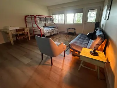 a living room with a couch and a bed at The Grove B&B Mayne Island in Mayne Island