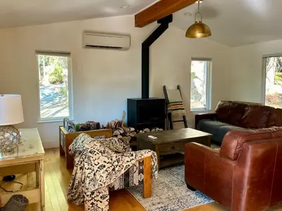 a living room with a couch and a table at The Grove B&B Mayne Island in Mayne Island