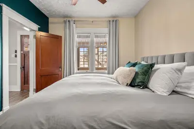 a bedroom with a large white bed with pillows at Dinos Last Post - Family Friendly 4 Bedrooms in Drumheller
