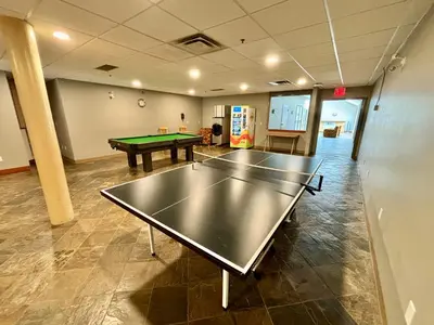 a large room with a ping pong table in it at Beachside Townhouses at The Pacific Shores Strata Property in Nanoose Bay