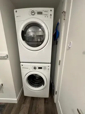 a washer and dryer in a small room at Juanus Cozy Cove in Edmonton