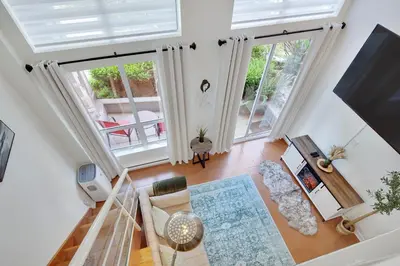 an overhead view of a living room with a large window at Stylish Two-Story Loft with Rooftop Deck in Vancouver