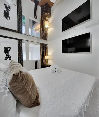 a bedroom with a large white bed with two pillows at Stylish Two-Story Loft with Rooftop Deck in Vancouver